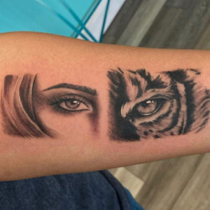 Woman and tiger eye tattoo