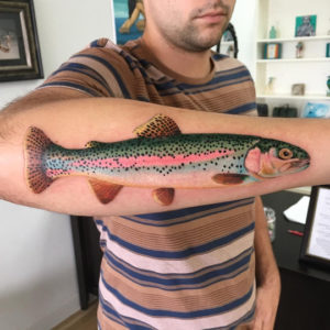 realistic fish tattoo on arm