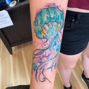 watercolor jellyfish tattoo on arm
